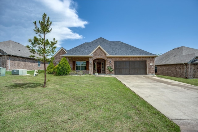 3331 Preston Club Dr, Sherman, TX 75092 - view of front of house with brick siding, an attached garage, driveway, a shingled roof, and a front yard