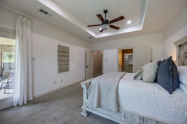3331 Preston Club Dr, Sherman, TX 75092 - bedroom with carpet floors, a tray ceiling, a spacious closet, baseboards, and a ceiling fan