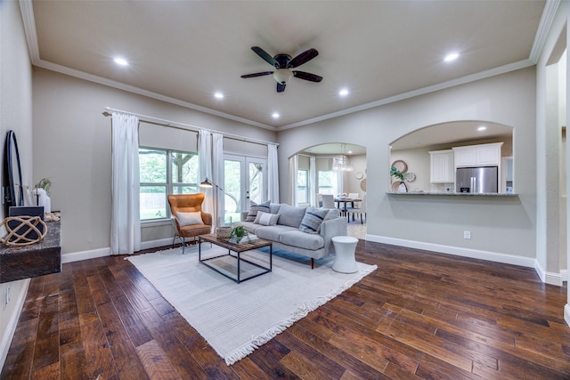 3331 Preston Club Dr, Sherman, TX 75092 - living area featuring arched walkways, a ceiling fan, crown molding, dark wood-type flooring, and baseboards