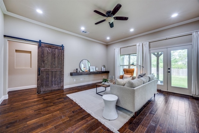 3331 Preston Club Dr, Sherman, TX 75092 - living room featuring dark wood-style flooring, ceiling fan, ornamental molding, a barn door, and baseboards