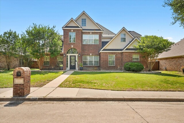 210 Sendero Dr, Waxahachie, TX 75165 - traditional-style house with a front yard and brick siding