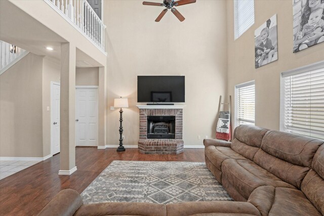 210 Sendero Dr, Waxahachie, TX 75165 - living room with a towering ceiling, a ceiling fan, wood finished floors, baseboards, and a fireplace