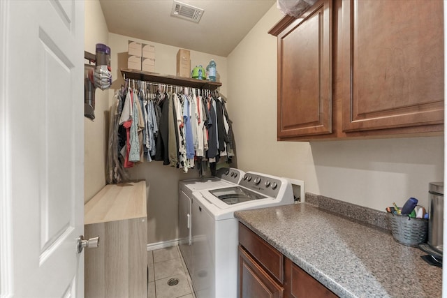 210 Sendero Dr, Waxahachie, TX 75165 - washroom with cabinet space, washer and clothes dryer, and light tile patterned floors
