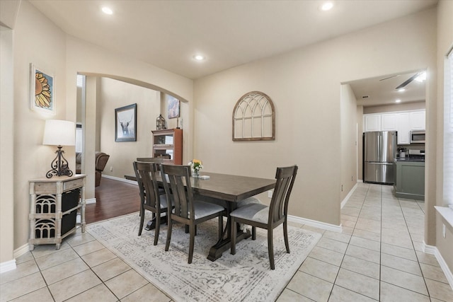 210 Sendero Dr, Waxahachie, TX 75165 - dining room featuring arched walkways, light tile patterned floors, recessed lighting, and baseboards