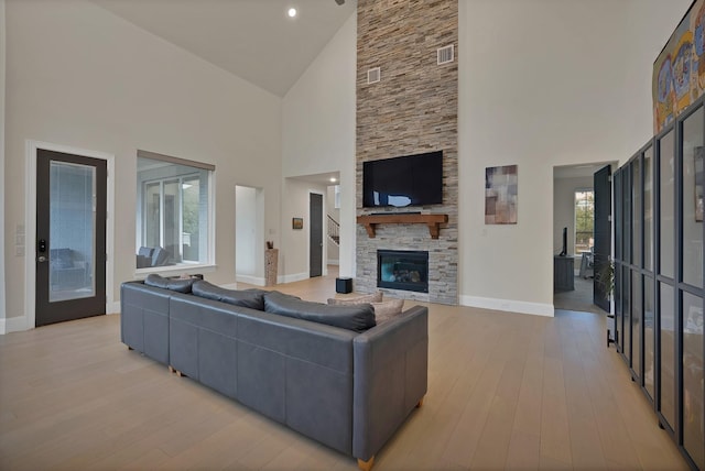 1306 Blue Lake Blvd, Arlington, TX 76005 - living room with high vaulted ceiling, baseboards, light wood-style flooring, and a fireplace