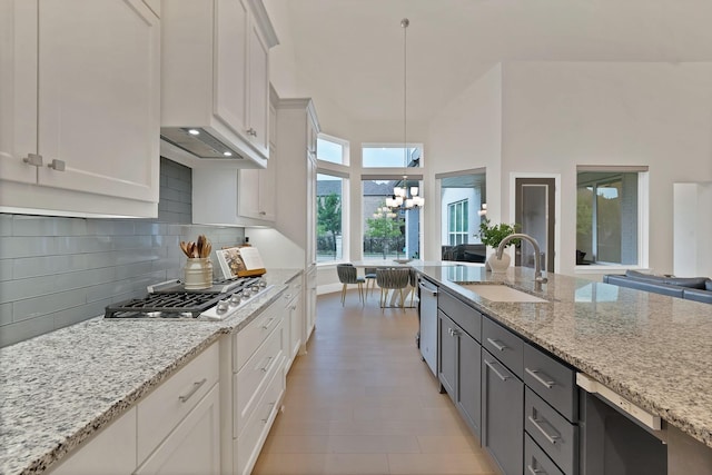 1306 Blue Lake Blvd, Arlington, TX 76005 - kitchen featuring a sink, white cabinets, a chandelier, and tasteful backsplash