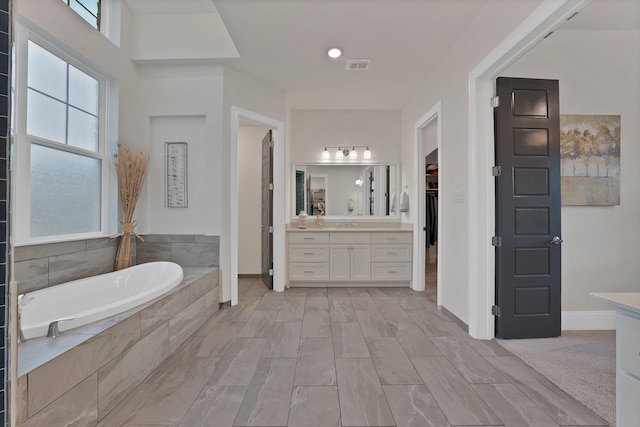 1306 Blue Lake Blvd, Arlington, TX 76005 - full bathroom with vanity, a garden tub, healthy amount of natural light, and a walk in closet