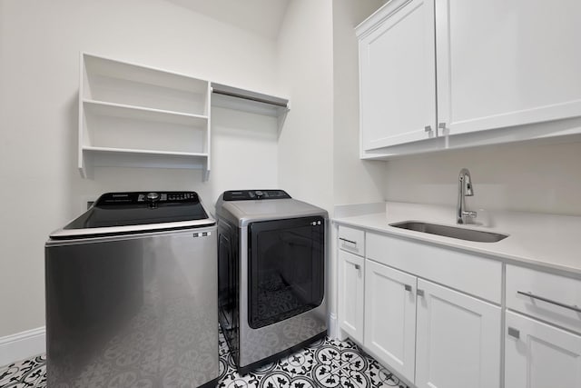 1306 Blue Lake Blvd, Arlington, TX 76005 - laundry room featuring washer and clothes dryer, cabinet space, tile patterned floors, and baseboards