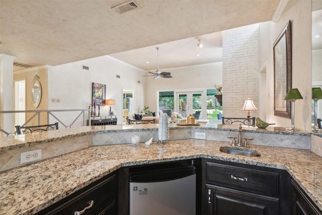 6 Crosslands Rd, Benbrook, TX 76132 - kitchen featuring fridge, a sink, light stone counters, ceiling fan, and open floor plan