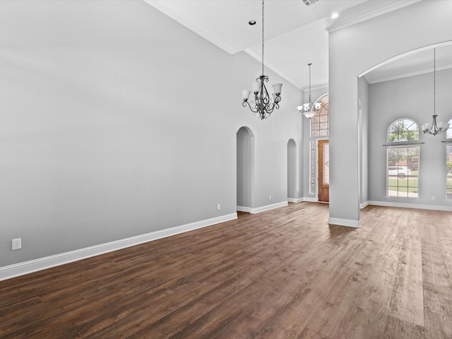 1105 Crown Valley Dr, Weatherford, TX 76087 - spare room with a chandelier, arched walkways, ornamental molding, baseboards, and dark wood finished floors