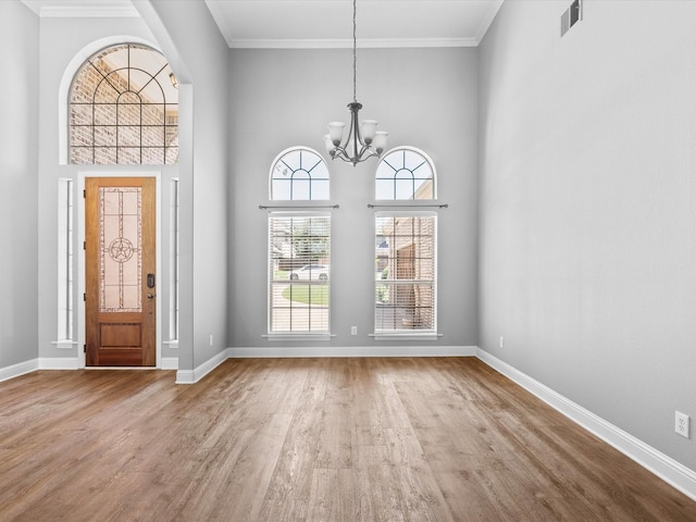 1105 Crown Valley Dr, Weatherford, TX 76087 - foyer entrance featuring wood finished floors, a chandelier, baseboards, crown molding, and a towering ceiling