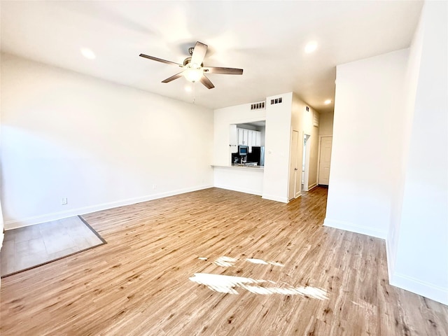 2807 Throckmorton St Unit 101, Dallas, TX 75219 - unfurnished living room featuring light wood-style floors, ceiling fan, baseboards, and recessed lighting