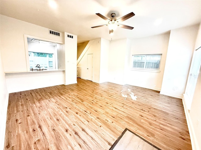 2807 Throckmorton St Unit 101, Dallas, TX 75219 - unfurnished living room with wood finished floors and ceiling fan