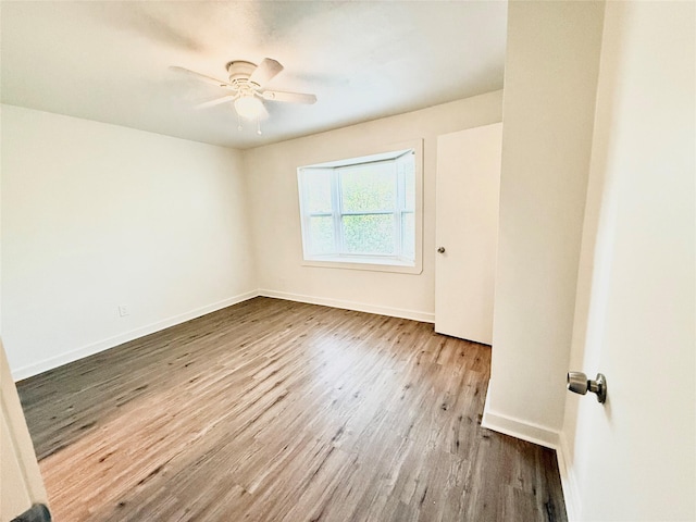 2807 Throckmorton St Unit 101, Dallas, TX 75219 - empty room with wood finished floors, a ceiling fan, and baseboards