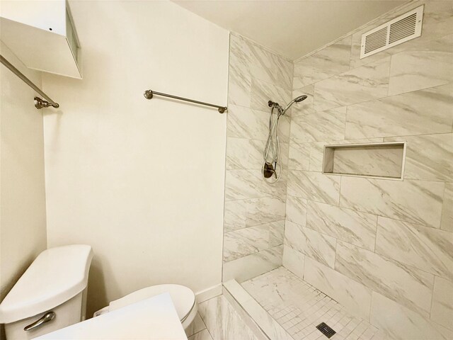 2807 Throckmorton St Unit 101, Dallas, TX 75219 - bathroom with toilet, tiled shower, and baseboards