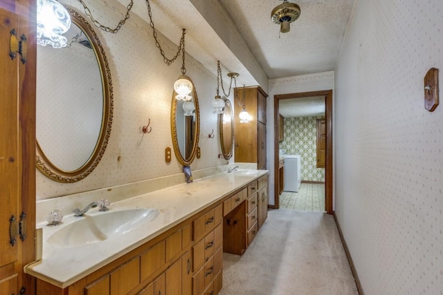 13220 Briar Rd, Azle, TX 76020 - full bath featuring wallpapered walls, double vanity, a textured ceiling, and washer / clothes dryer