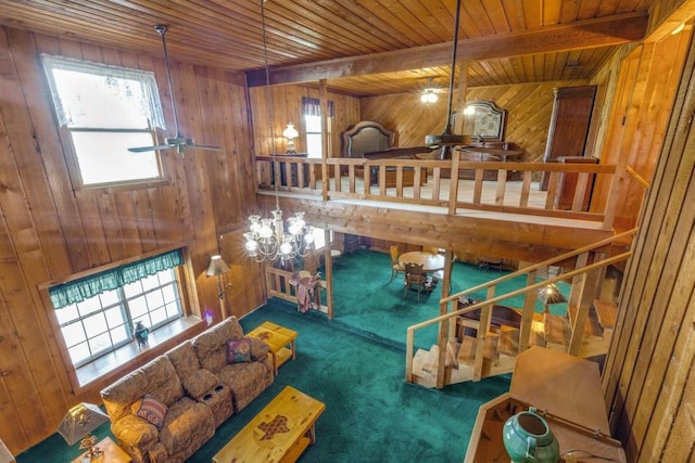 13220 Briar Rd, Azle, TX 76020 - carpeted living area with a ceiling fan, wood walls, and wooden ceiling with exposed beams