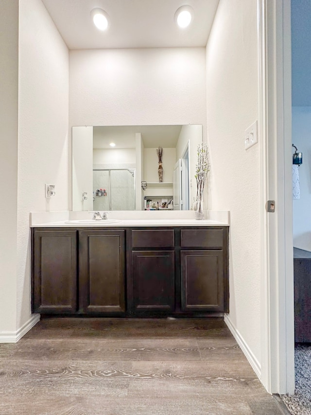3225 Conley Ct, Mesquite, TX 75126 - full bath with wood finished floors, a shower stall, vanity, and baseboards