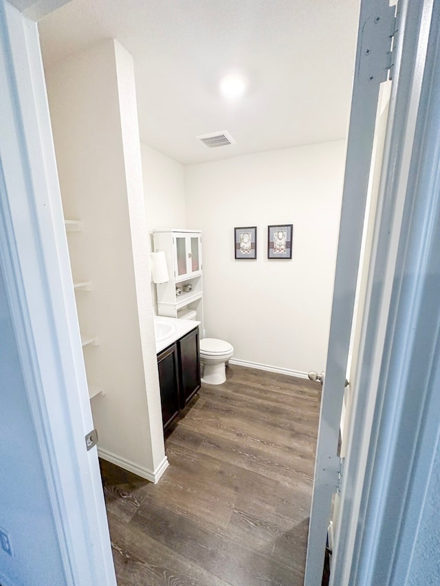 3225 Conley Ct, Mesquite, TX 75126 - bathroom with vanity, toilet, wood finished floors, and baseboards