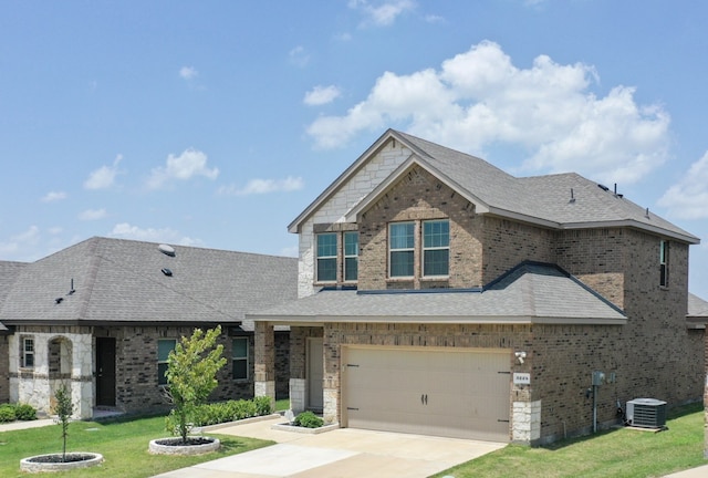 3225 Conley Ct, Mesquite, TX 75126 - view of front of home featuring central air condition unit, an attached garage, a front yard, concrete driveway, and roof with shingles