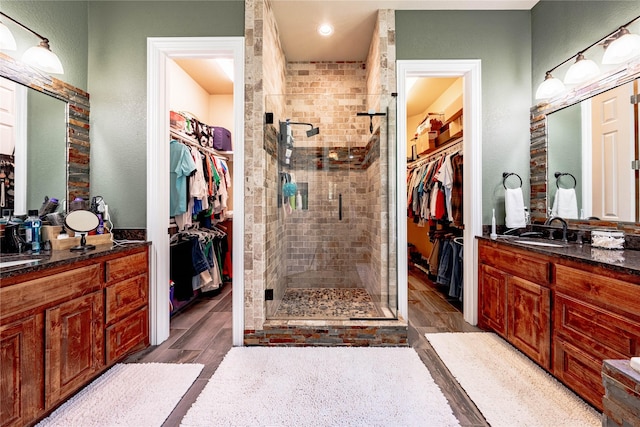 6296 Fm 1256, Mabank, TX 75147 - full bathroom featuring a spacious closet, a shower stall, vanity, and wood finished floors