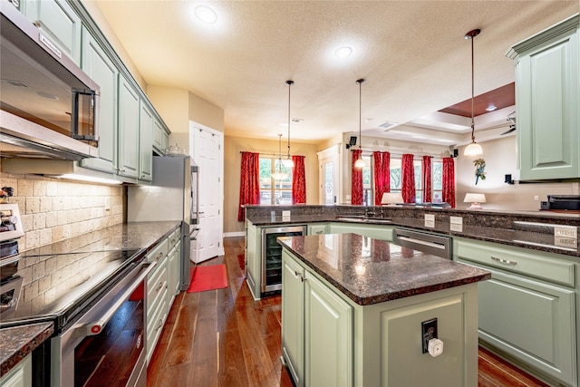 6296 Fm 1256, Mabank, TX 75147 - kitchen with appliances with stainless steel finishes, wine cooler, a peninsula, green cabinetry, and recessed lighting
