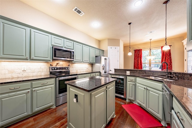 6296 Fm 1256, Mabank, TX 75147 - kitchen with appliances with stainless steel finishes, beverage cooler, a sink, a textured ceiling, and decorative backsplash