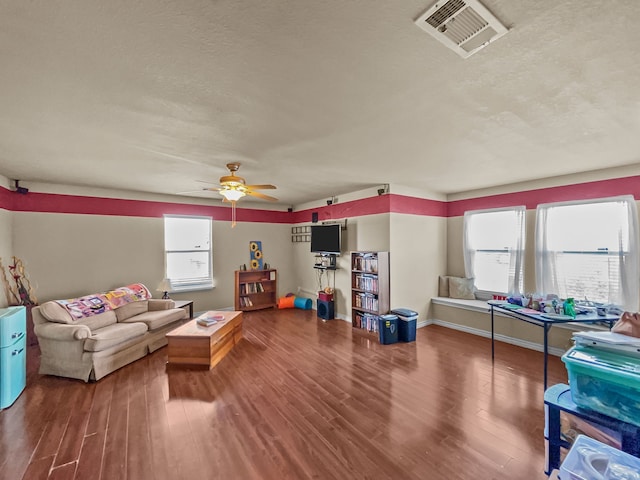 301 Quail Run Rd, Red Oak, TX 75154 - living area with wood finished floors, ceiling fan, a textured ceiling, and baseboards