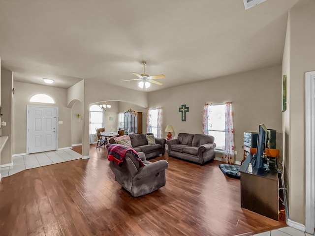 301 Quail Run Rd, Red Oak, TX 75154 - living room featuring arched walkways, a chandelier, wood finished floors, ceiling fan, and baseboards