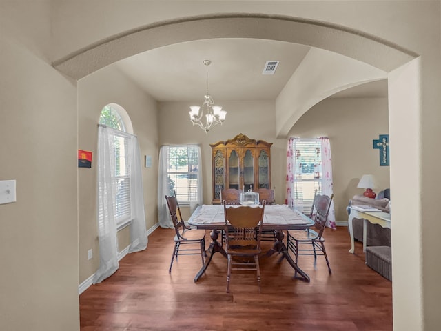 301 Quail Run Rd, Red Oak, TX 75154 - dining room featuring wood finished floors, arched walkways, a chandelier, and baseboards