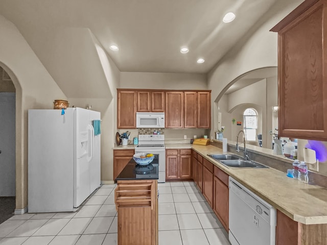 301 Quail Run Rd, Red Oak, TX 75154 - kitchen with white appliances, a sink, a center island, light tile patterned floors, and brown cabinets