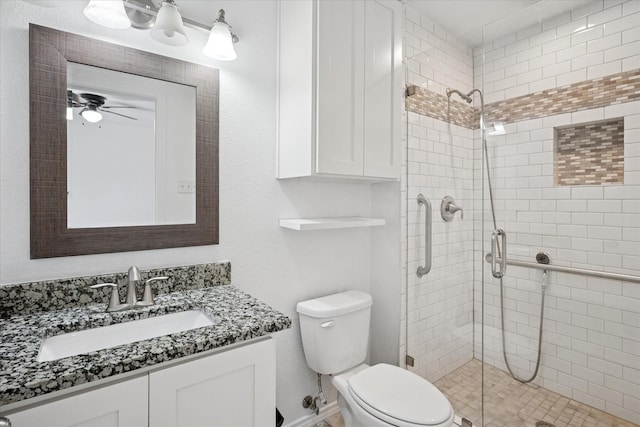 5409 Queens Ct, Lake Dallas, TX 75065 - bathroom featuring a stall shower, toilet, vanity, and ceiling fan