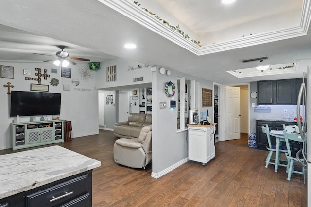 7028 Whitewood Dr, Fort Worth, TX 76137 - living area with ceiling fan, a tray ceiling, dark wood-style flooring, and baseboards