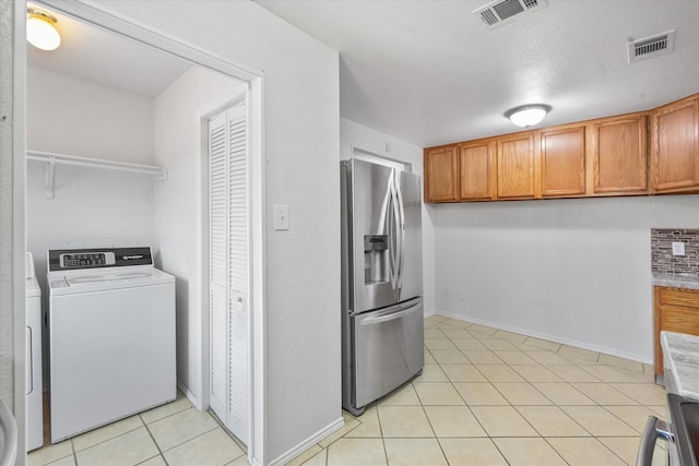 415 Blueberry Hill Ln, Mansfield, TX 76063 - laundry room with separate washer and dryer, light tile patterned flooring, and baseboards