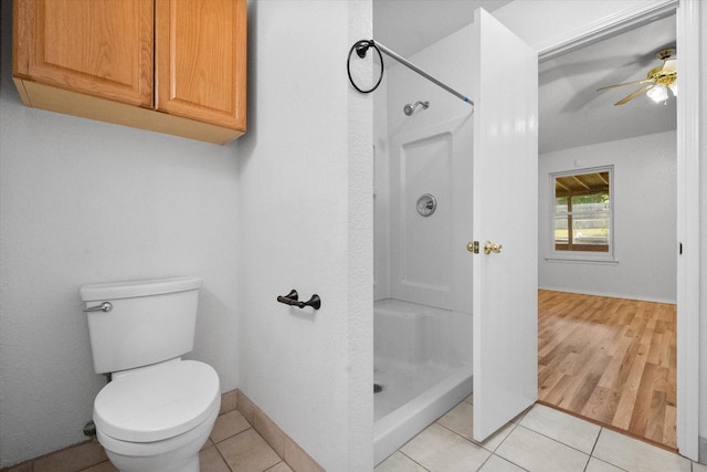 415 Blueberry Hill Ln, Mansfield, TX 76063 - bathroom with a stall shower, a ceiling fan, toilet, and tile patterned floors