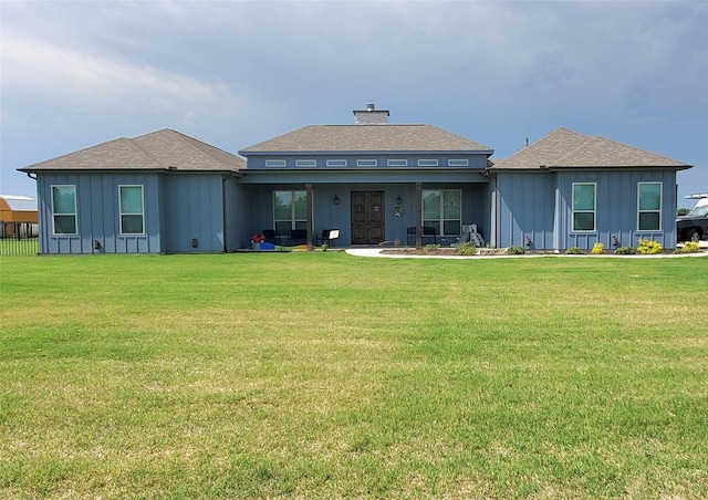 291 County Road 4833, Leonard, TX 75452 - back of property featuring board and batten siding, a lawn, and a shingled roof