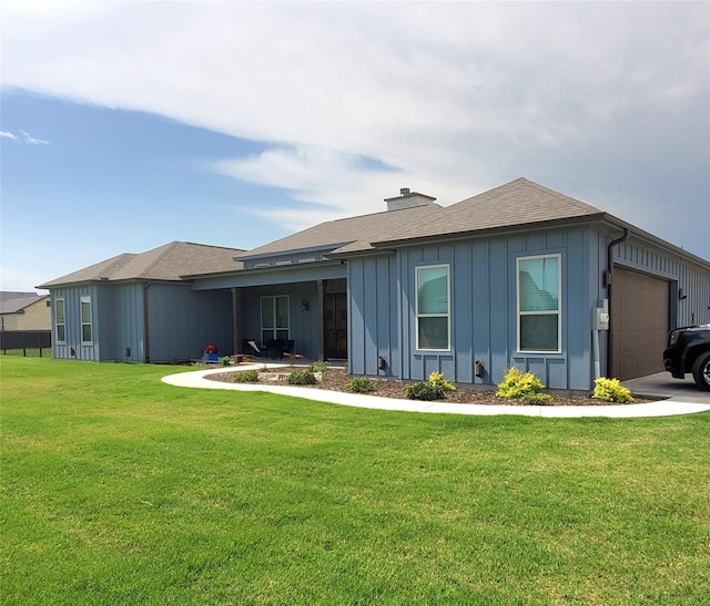 291 County Road 4833, Leonard, TX 75452 - view of front facade with board and batten siding, a front lawn, a chimney, an attached garage, and a shingled roof