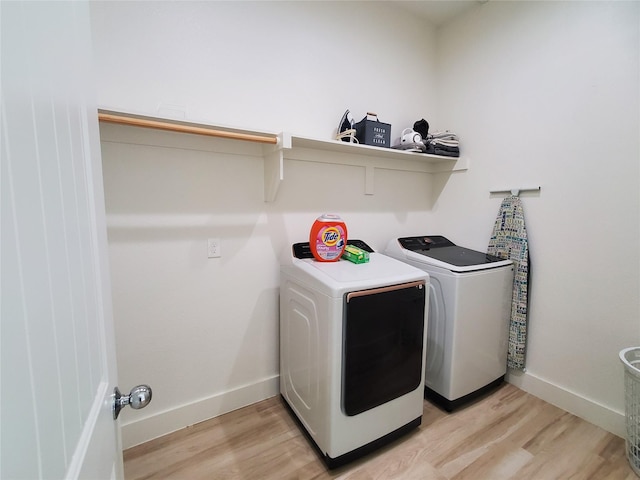 291 County Road 4833, Leonard, TX 75452 - laundry area featuring washer and clothes dryer, light wood-type flooring, and baseboards