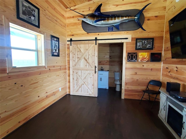 291 County Road 4833, Leonard, TX 75452 - interior space with wooden walls, a barn door, and dark wood-style floors