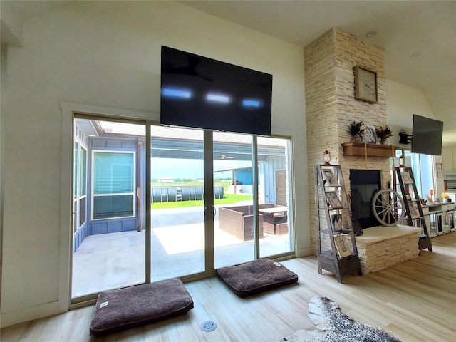 291 County Road 4833, Leonard, TX 75452 - living area with wood finished floors, a high ceiling, and a fireplace