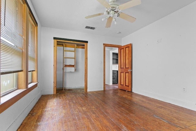 314 Dunn St, Waxahachie, TX 75165 - unfurnished bedroom with hardwood / wood-style floors, baseboards, a closet, and a ceiling fan