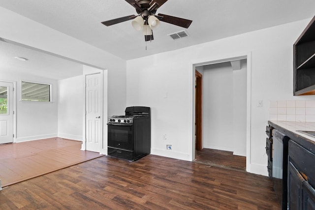 314 Dunn St, Waxahachie, TX 75165 - unfurnished living room with a ceiling fan, dark wood-style floors, and baseboards