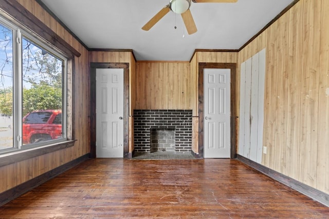 314 Dunn St, Waxahachie, TX 75165 - unfurnished living room featuring wood walls, wood finished floors, a ceiling fan, ornamental molding, and baseboards