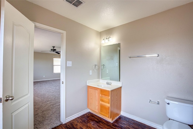 1057 Castle Top Dr, Fort Worth, TX 76052 - bathroom featuring vanity, ceiling fan, toilet, baseboards, and wood finished floors