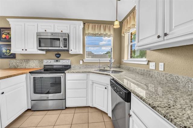 121 Sanchez Creek Ct, Weatherford, TX 76088 - kitchen featuring appliances with stainless steel finishes, white cabinetry, a sink, and light tile patterned floors