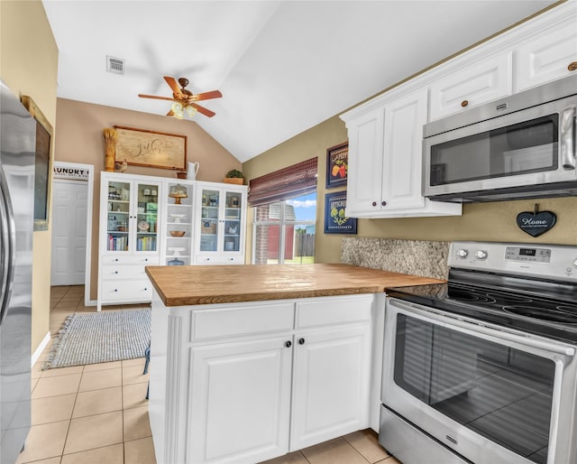 121 Sanchez Creek Ct, Weatherford, TX 76088 - kitchen with stainless steel appliances, wooden counters, ceiling fan, light tile patterned floors, and vaulted ceiling