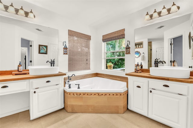 121 Sanchez Creek Ct, Weatherford, TX 76088 - full bathroom with two vanities, a tub with jets, and tile patterned floors