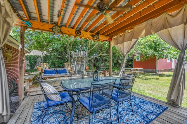 121 Sanchez Creek Ct, Weatherford, TX 76088 - wooden terrace with outdoor dining area, a ceiling fan, and an outdoor structure