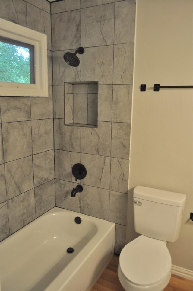722 Sunset St, Sulphur Springs, TX 75482 - full bathroom with wood finished floors, toilet, washtub / shower combination, and baseboards