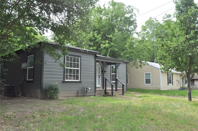 722 Sunset St, Sulphur Springs, TX 75482 - view of front of home with central air condition unit and a front yard